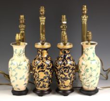 A pair of modern table lamps, each of inverted baluster form, decorated with an all over foliate