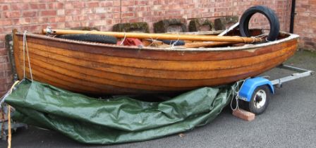 A vintage wooden sailing dinghy, of planked construction, the hull 365cm long, the removable mast