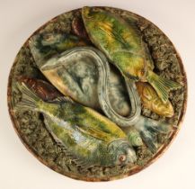 A Palissy style continental earthenware charger, late 19th century, the brown mottled glazed charger