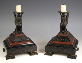 A pair of Egyptian revival patinated bronze, polished slate and rouge marble candle sconces, late