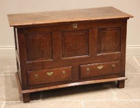 An early 18th century oak mule chest, the three plank top opening to a fitted candle box and two