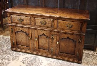 A George III style oak dresser base, late 20th century, in the manner of Titchmarsh and Goodwin, the