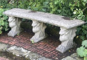 A Haddonstone curved garden bench, on three pedestals, 150cm wide