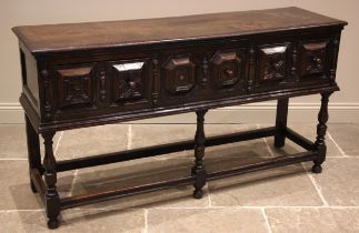 A Jacobean style oak sideboard, 17th century and later, the moulded plank top, over three frieze oak
