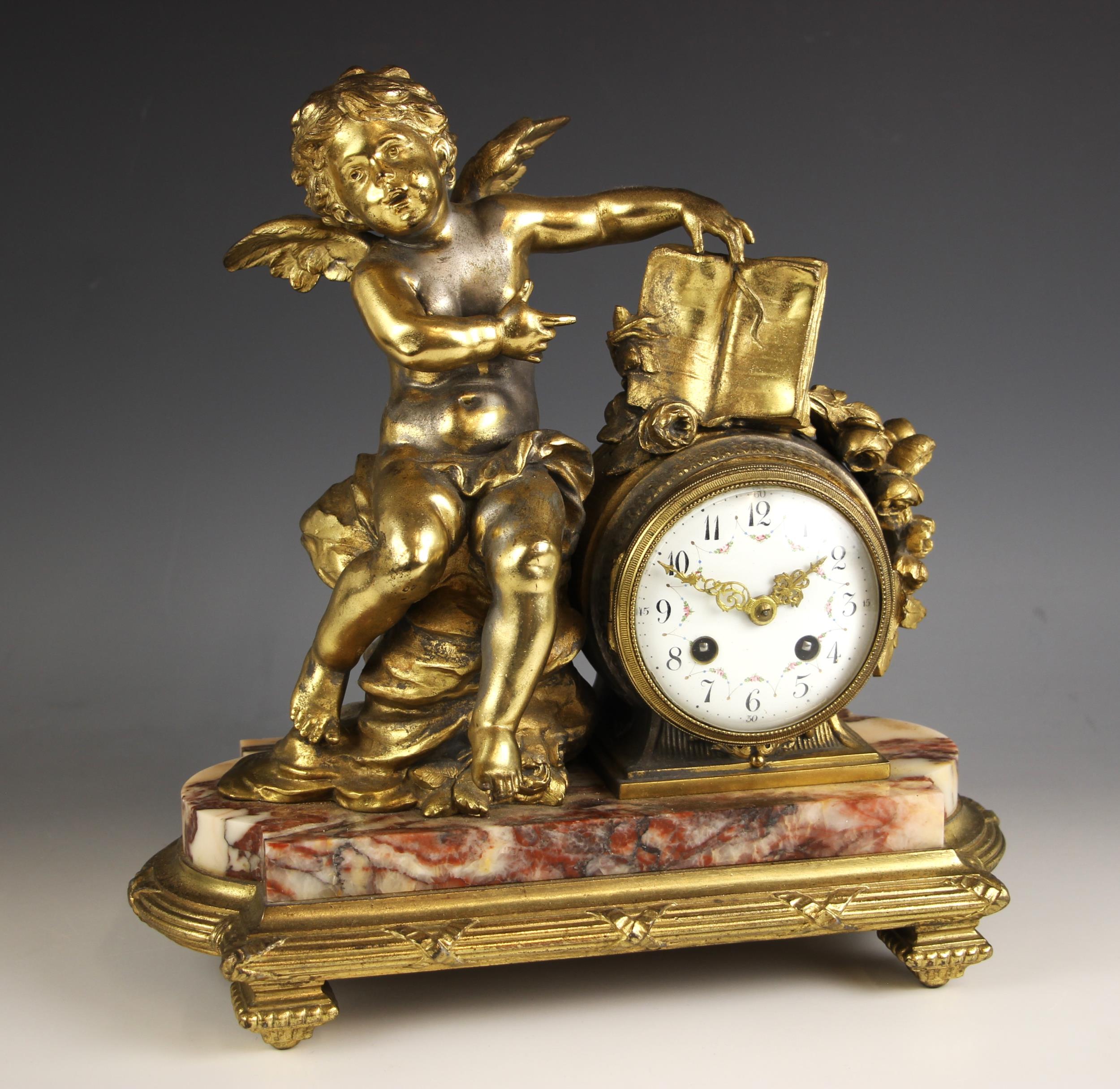 A French gilt metal and rouge marble mantel clock, late 19th century, the case surmounted with a