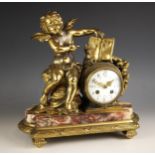 A French gilt metal and rouge marble mantel clock, late 19th century, the case surmounted with a