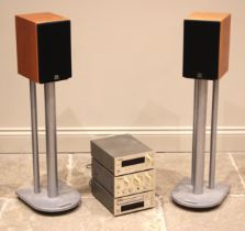 A pair of Monitor Audio Monitor 2 hi-fi speakers on Atacama stands, with a Teac stereo system