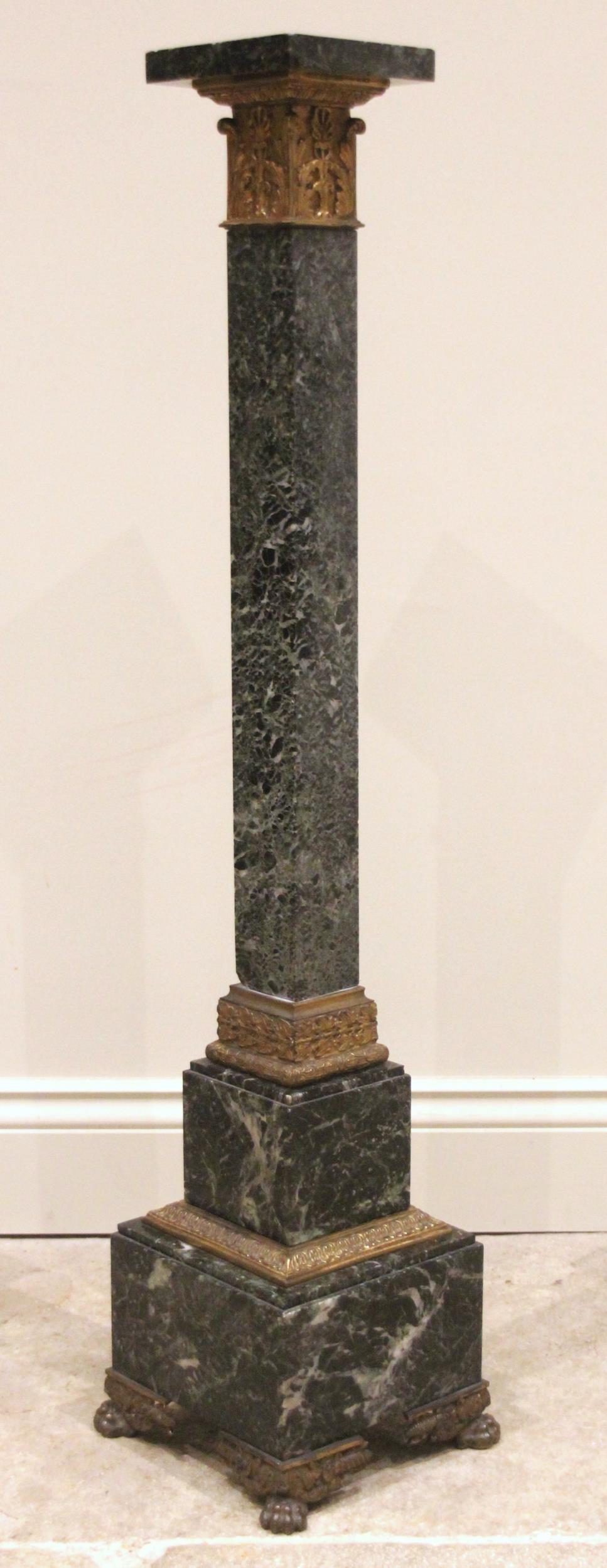 A green marble pedestal, early 20th century, with gilt metal mounts, the square stand on