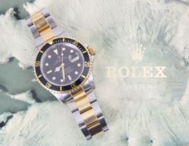 A Rolex Submariner Oyster perpetual date bi-colour wristwatch, the circular black dial with baton