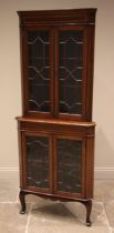 An Edwardian mahogany and satinwood banded freestanding corner display cabinet, the moulded and