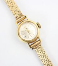 A yellow metal Bucherer ladies wrist watch, the circular white dial with baton markers, set to plain