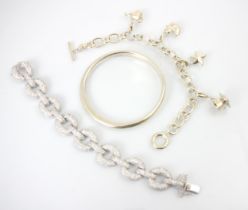 A group of three bracelets, to include a Mappin and Webb charm bracelet, the curb links suspending