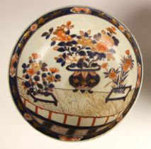 A Japanese Arita imari porcelain circular bowl, 18th century, the circular bowl centrally decorated