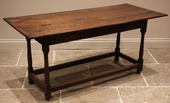 An 18th century oak refectory type table, of cottage proportions, the rectangular cleated plank