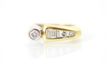 A yellow and white metal diamond set dress ring, the round cut diamond set within white metal rub