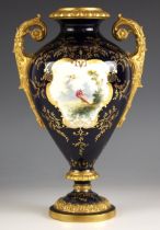 A Coalport porcelain twin handled urn, late 19th century, decorated with a central cartouche