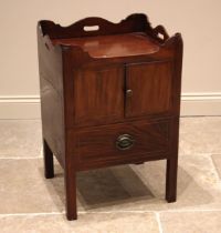 A George III mahogany tray top bedside chest, the galleried top above a pair of cupboard doors and a