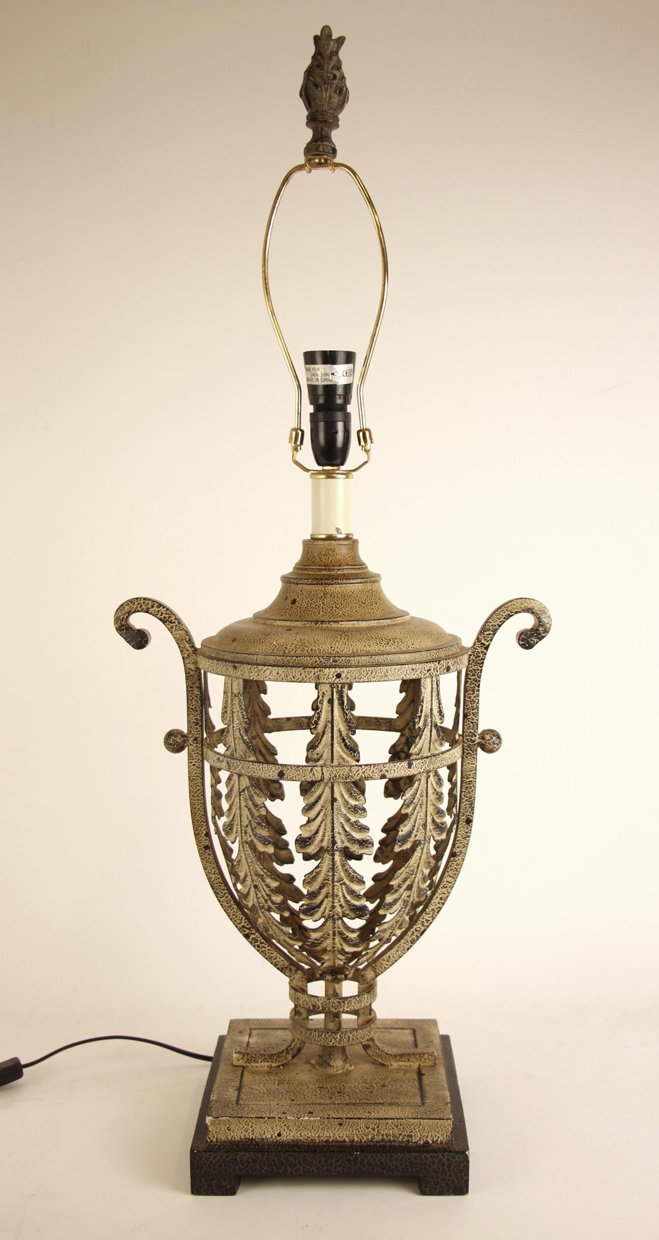 A continental metal table lamp base, of urn form, the body pierced throughout with foliate panels,