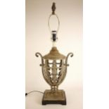 A continental metal table lamp base, of urn form, the body pierced throughout with foliate panels,