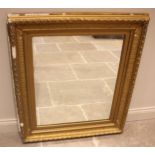 A 19th century giltwood and gesso wall mirror, the frame moulded with foliate and beaded detail,