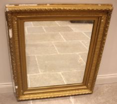 A 19th century giltwood and gesso wall mirror, the frame moulded with foliate and beaded detail,