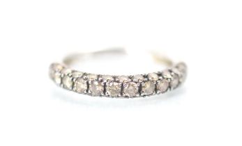 A white metal brown diamond half eternity, the row of twelve round cut diamonds with eleven