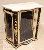 An Italian ebonised and painted marble top vitrine, 19th century, of serpentine form, the glazed