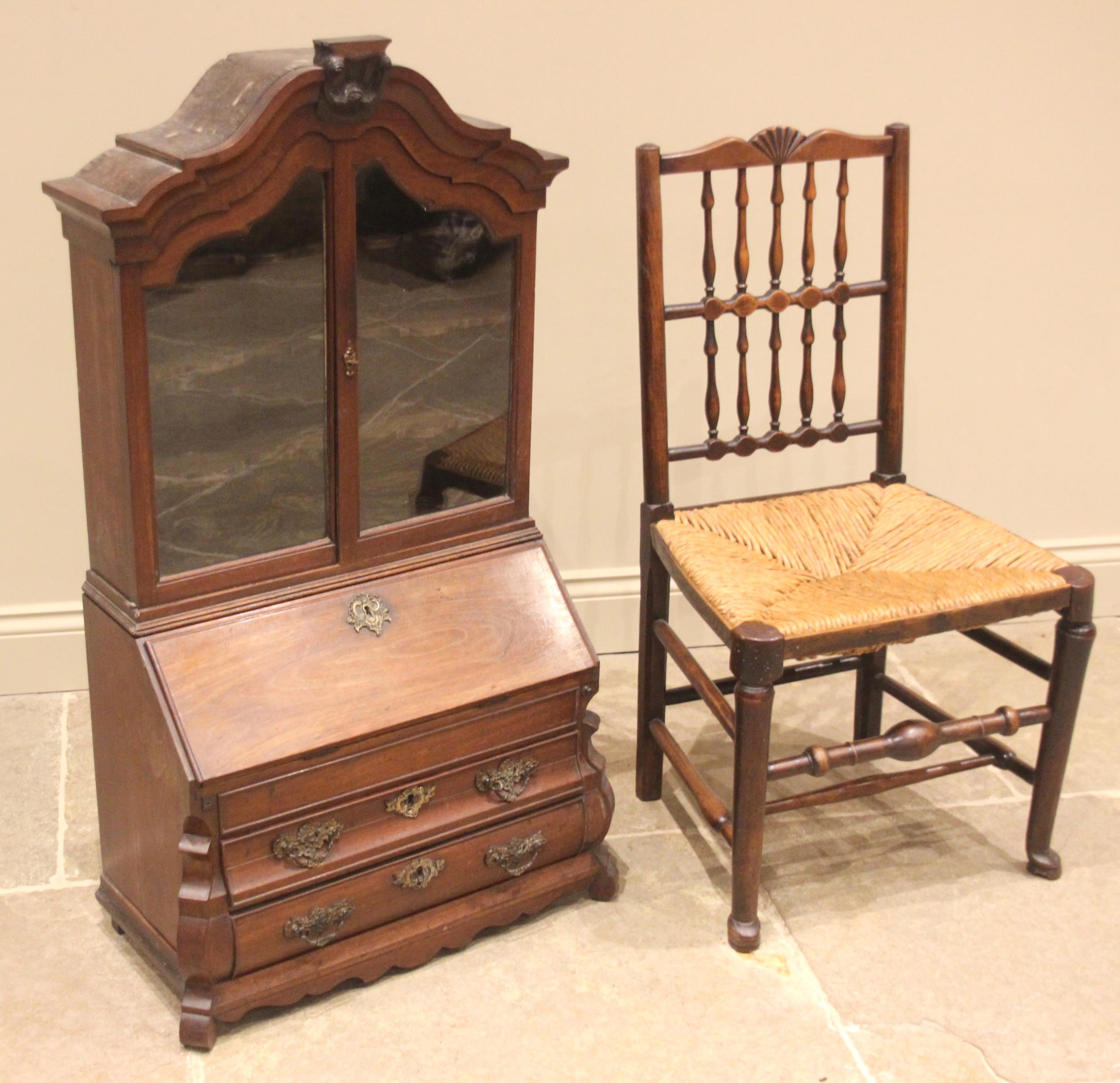 An 18th century Dutch walnut apprentice bombe bureau bookcase, the arched top with a carved crest - Image 3 of 4