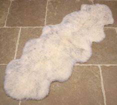 A single sheepskin rug, with grey fleck, Australian/New Zealand origin, 180cm x 63cm