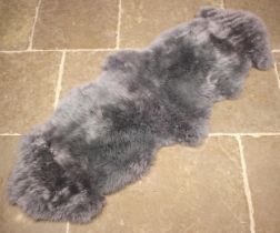 A single sheepskin grey rug, Australian/New Zealand origin, 180cm x 63cm