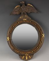 A Regency style wood and gesso wall mirror, the convex mirror plate set to a reeded ribboned frame