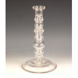 A glass lamp base, 20th century, of multi knopped form, on spreading circular foot with faux