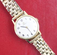 A yellow metal Omega wristwatch, the circular cream dial with Arabic numerals, set to plain polished