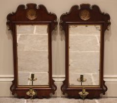 A pair of George III mahogany fretwork girandole wall mirrors, each with an inverted gilt painted
