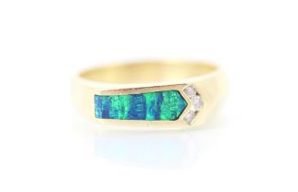 A yellow metal diamond and opal doublet dress ring, the arrow shaped slice of opal doublet with