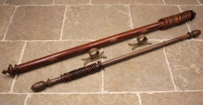 A Victorian mahogany curtain pole, of typical cylindrical form, with turned finials and wooden