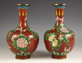 A pair of Chinese cloisonne vases, early 20th century, each bottle form and decorated against a