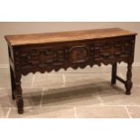 A 17th century and later Jacobean style dresser base, the moulded two plank top above three