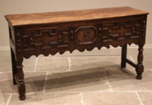A 17th century and later Jacobean style dresser base, the moulded two plank top above three