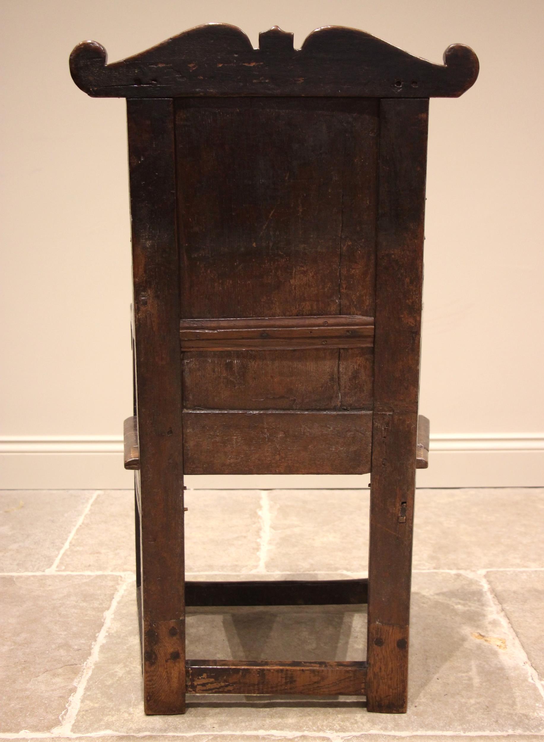 A 17th century oak Lancashire Wainscot chair, the panelled back with a shaped top rail extending - Image 2 of 8