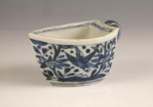 A Chinese porcelain blue and white sauce boat, 18th century, of boat form and decorated birds amidst