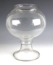 A glass leech jar, early 19th century, the compressed spherical body with flared rim, raised on an