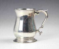 A George II silver mug, Thomas Parr II, London 1752, the scroll handle above baluster body with