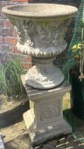 A pair of reconstituted Haddonstone type Campana shaped garden urns, upon associated plinths,