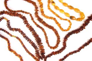 A selection of 'amber' coloured necklaces, including a 'amber' panelled necklace, a butterscotch