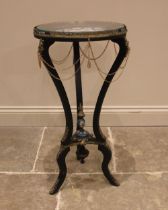 A French ebonised Sevres inset gueridon, the circular top inset with a glazed panel over a Sevres