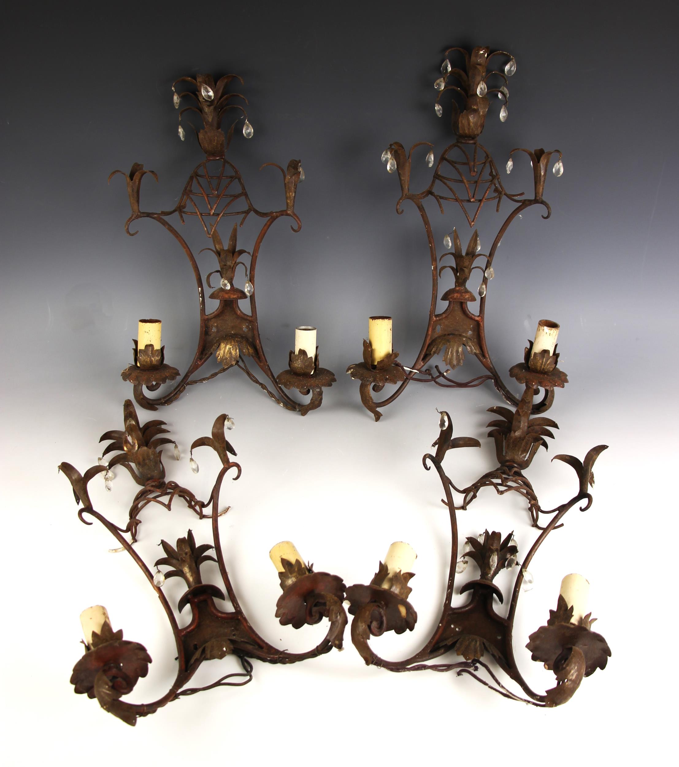 Four toleware and wirework style twin branch wall sconces, each with pineapple finial, and hanging