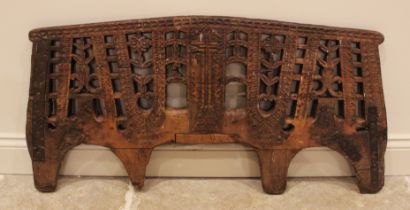 An Indian carved hardwood open work panel, 19th century, of gently arched form, carved with