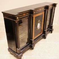 A Victorian ebonised and walnut banded credenza, the central cupboard door inset with an oval French