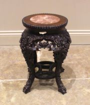 A Chinese carved hardwood and rouge marble jardiniere stand, 19th century, the circular inset marble